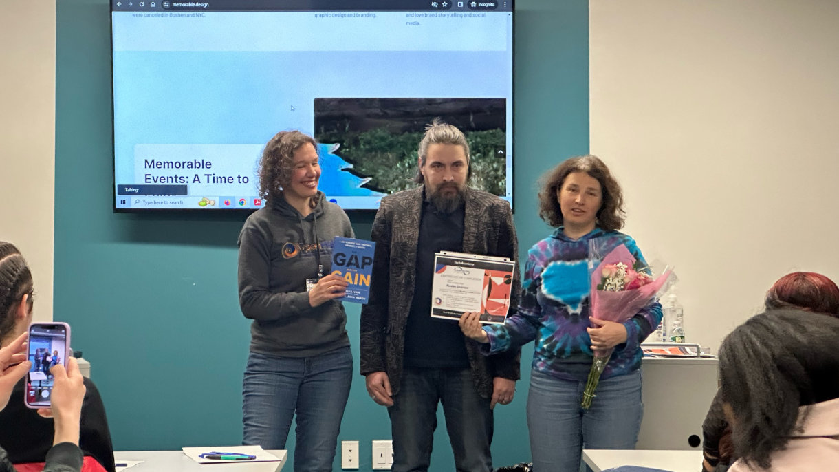 a group of people standing in front of a screen